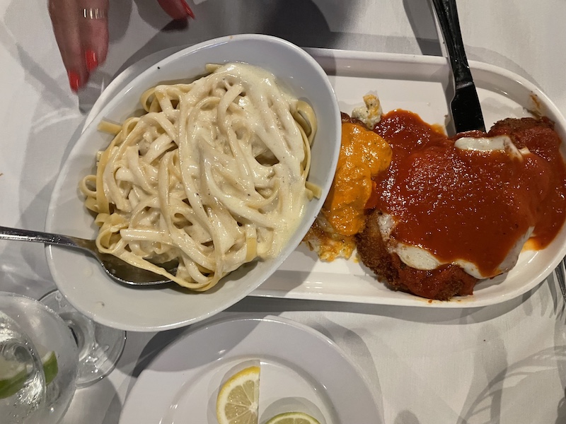 Mezzaluna Trio plate with lasagna, eggplant rollatini, and chicken parmigiana at Mezza Luna at The Villages