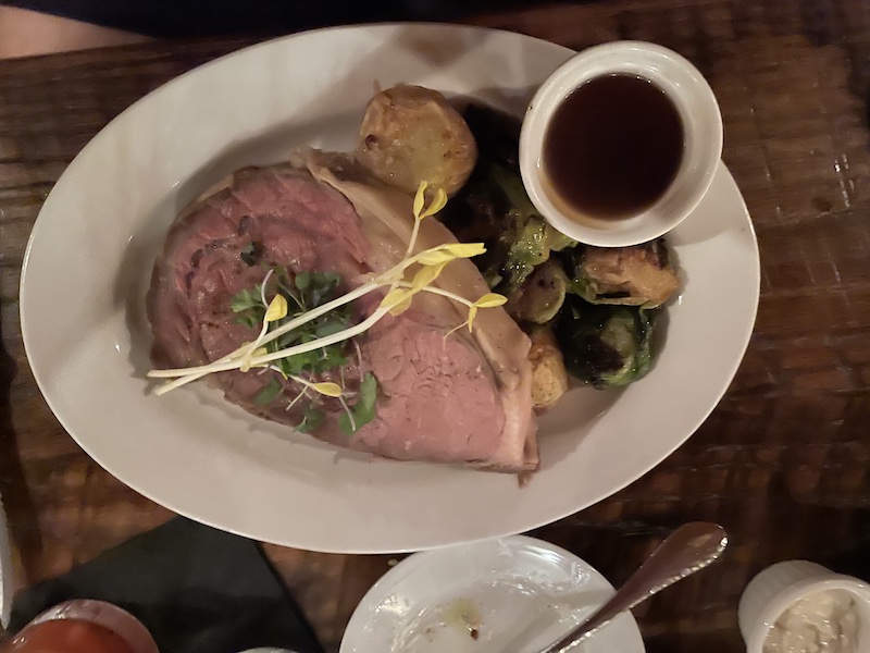Prime rib dinner with roasted potatoes and Brussels sprouts