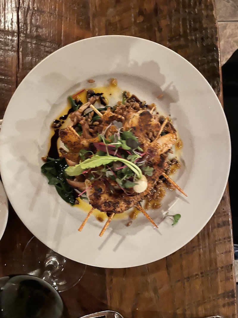 Blackened shrimp with farro and shiitake mushrooms on white plate