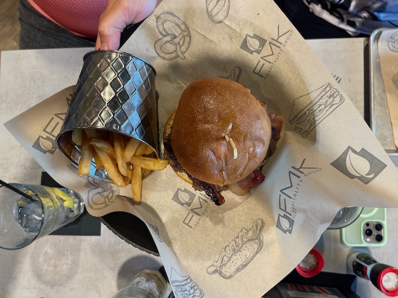 Jalapeño Smash Burger with fries served in a tin cup.
