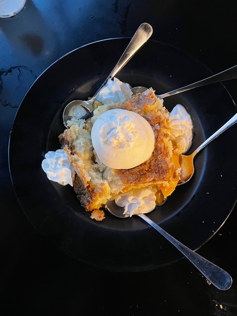 Peach cobbler dessert with vanilla ice cream