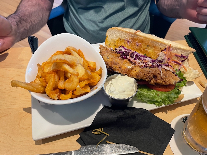 Haddock sandwich served for lunch at Boosters with coleslaw, lettuce, tomato, and fries