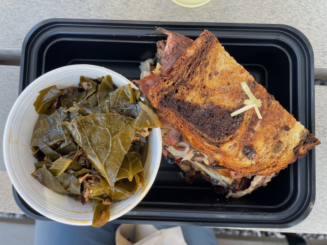 Beef belly pastrami Reuben sandwich with collard greens