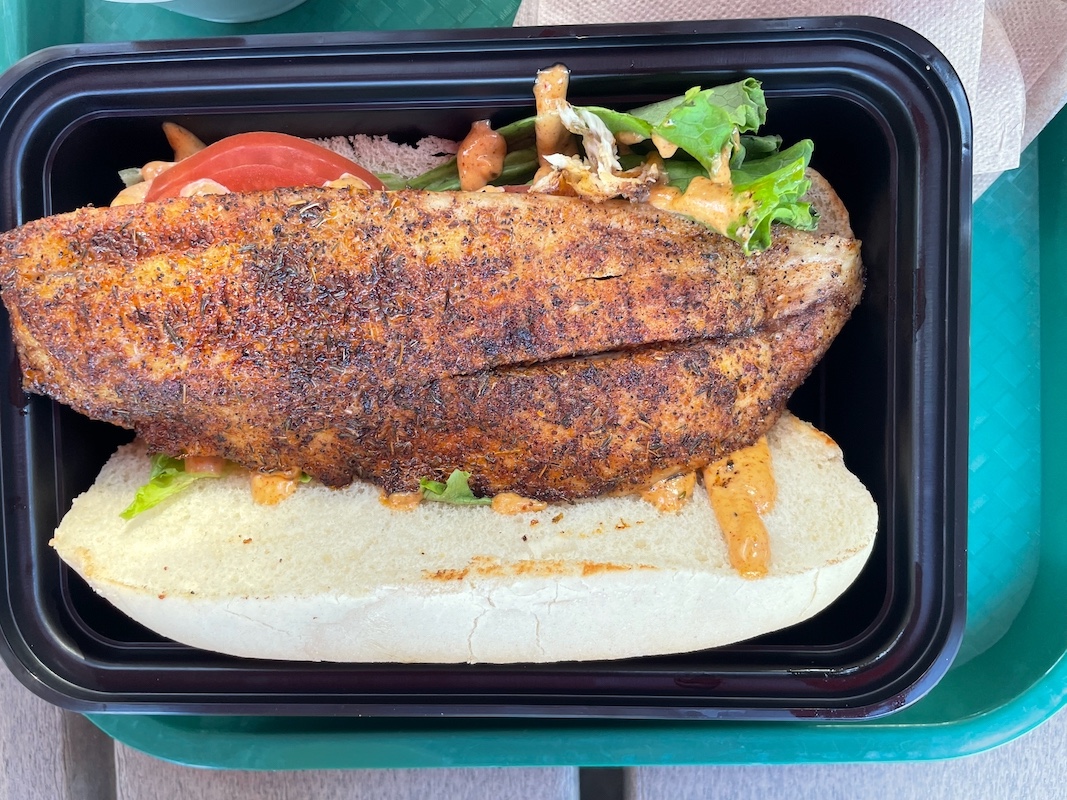Blackened redfish po’ boy with lettuce and tomato