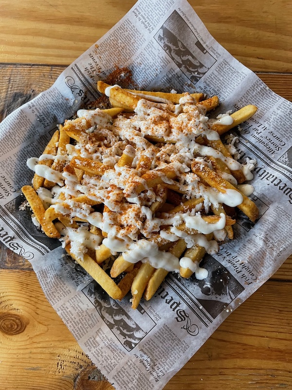 Crab fries served on newspaper-style liner at The Anchor