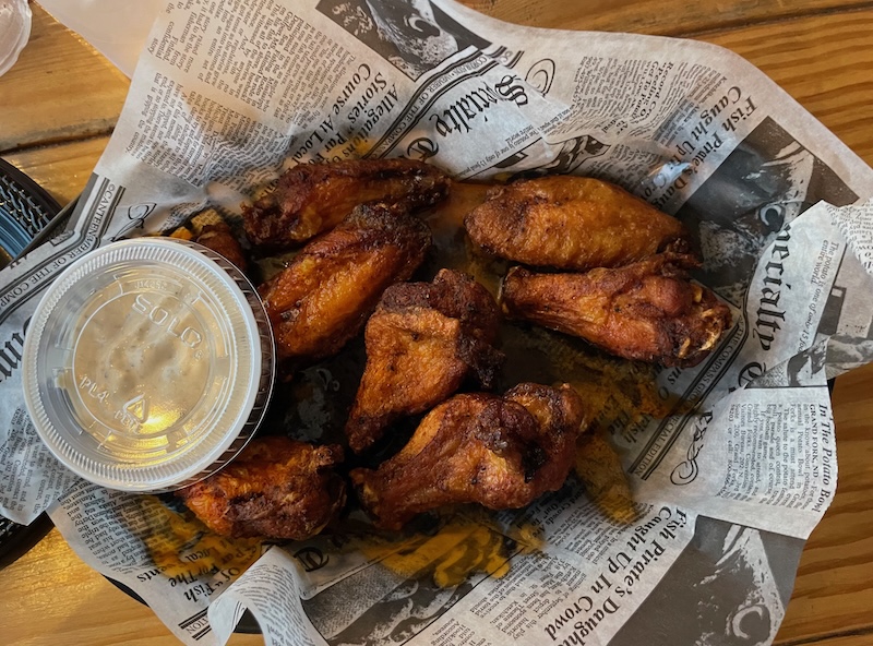 Order of wings served with dipping sauce at The Anchor on Sunset Harbor