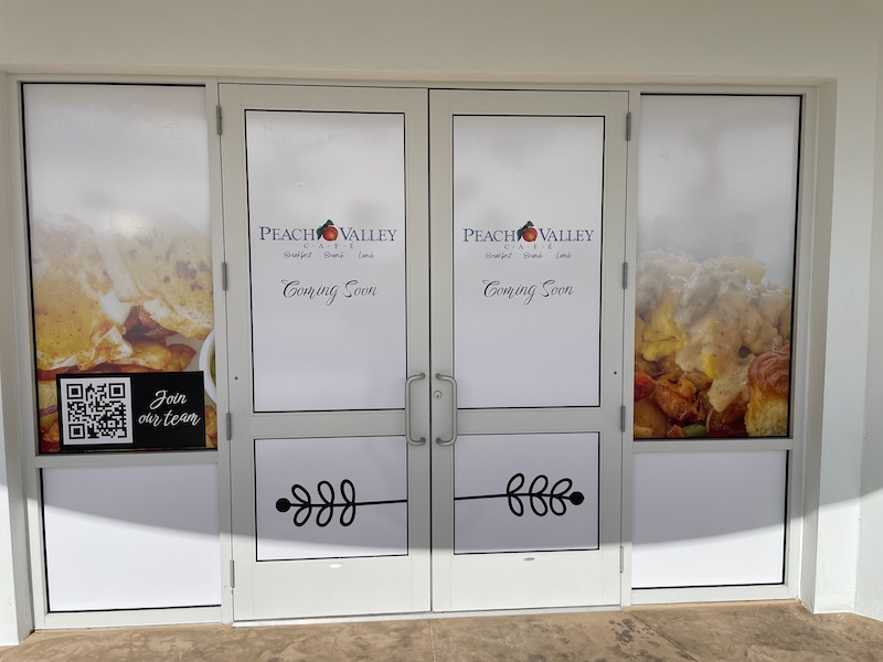 Peach Valley Café storefront at Eastport in The Villages with “Coming Soon” window graphics and a “Join our team” sign