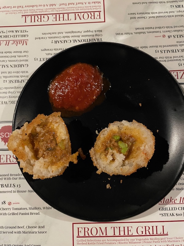 Arancini cut open showing filling at RedSauce Lake Sumter Landing