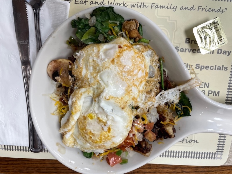 Garden skillet with eggs potatoes spinach mushrooms and cheese at Breakfast Station