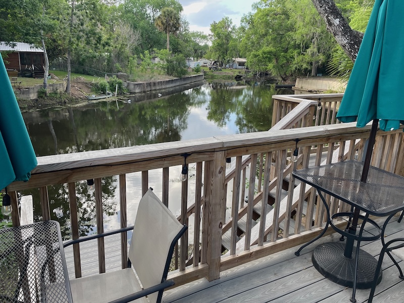 Waterfront outdoor dining area at Fisherman’s Cove overlooking canal