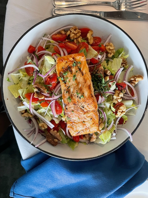Salmon salad with walnuts, tomatoes, and onions