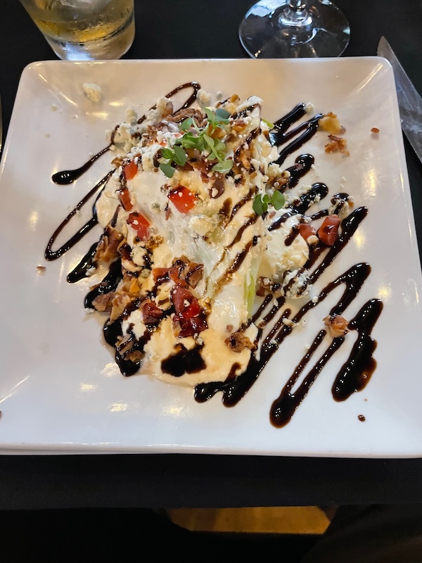 Wedge salad with dressing and toppings