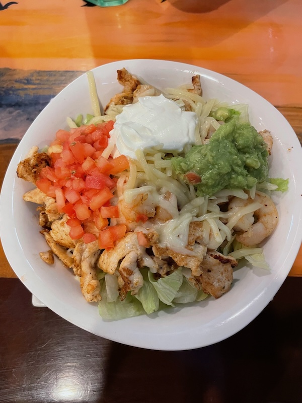 Chicken and shrimp taco salad served without a tortilla shell