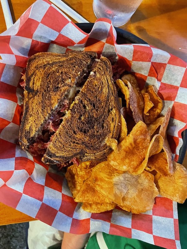 Hot Reuben sandwich with house-made potato chips at The Cove Resort and Pub