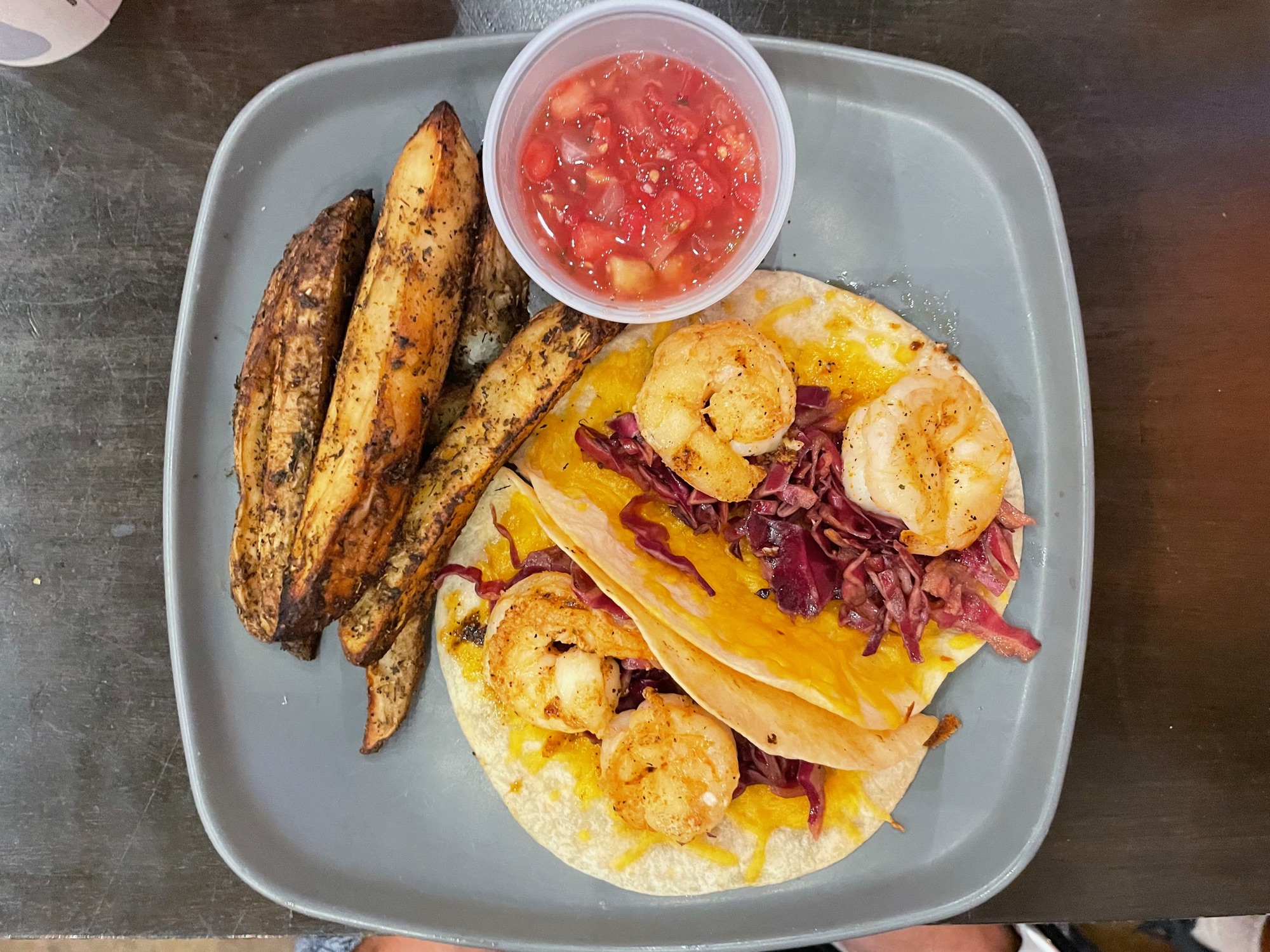 Shrimp tacos with seasoned potato wedges at Flying Boat Tap Room