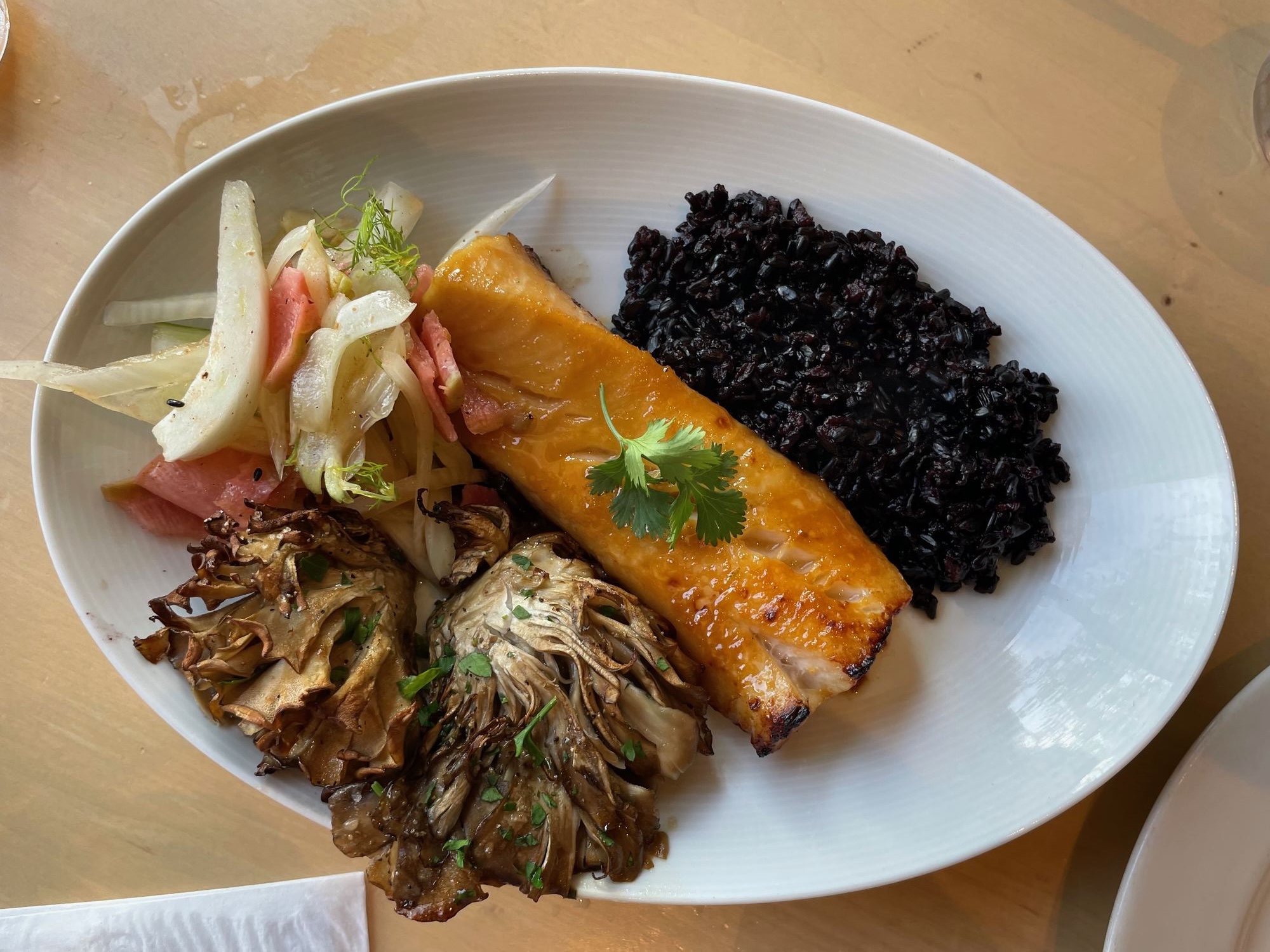 Miso cod with black rice and maitake mushrooms at Wolfgang Puck Kitchen + Bar in Brownwood