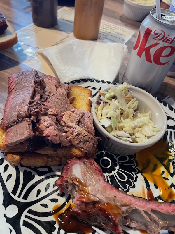 Sliced smoked brisket on toast with coleslaw at J&T Smokehouse